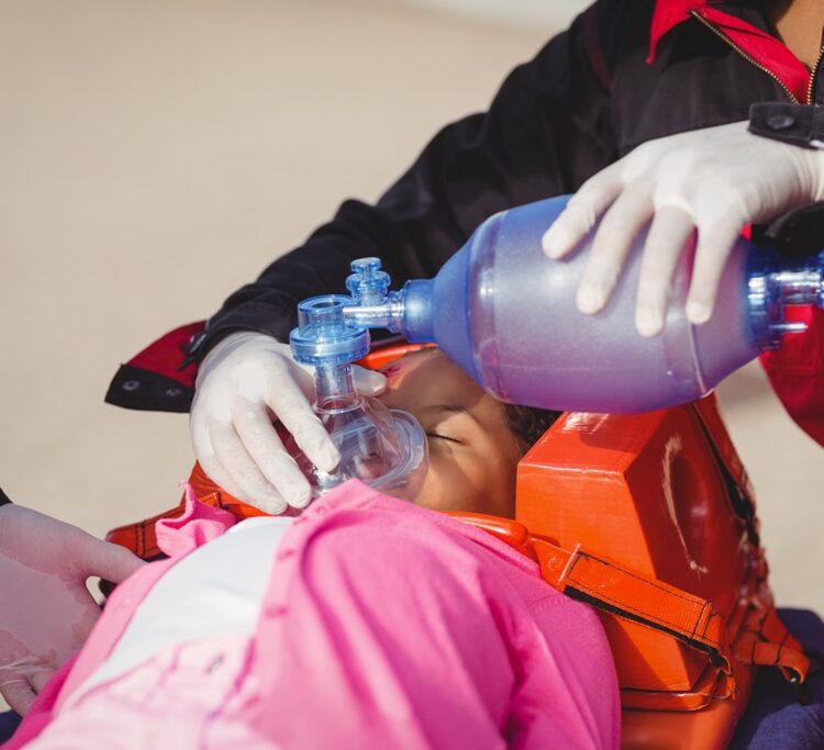 Paramedic giving oxygen to injured girl